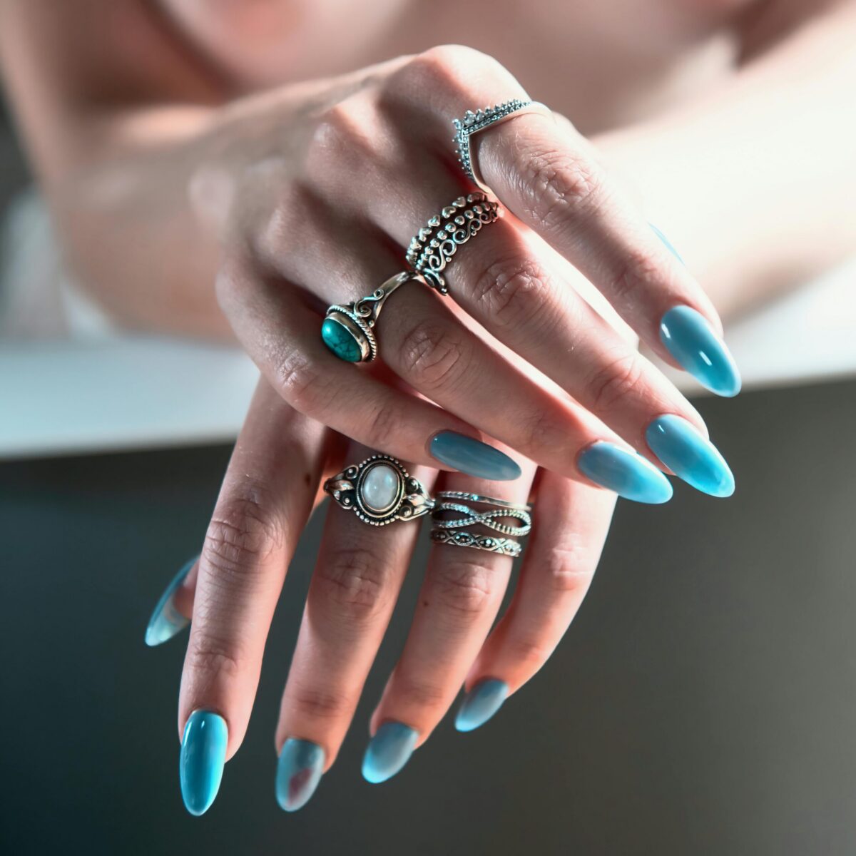 Close-up of a manicure being performed with a nail file on a hand.