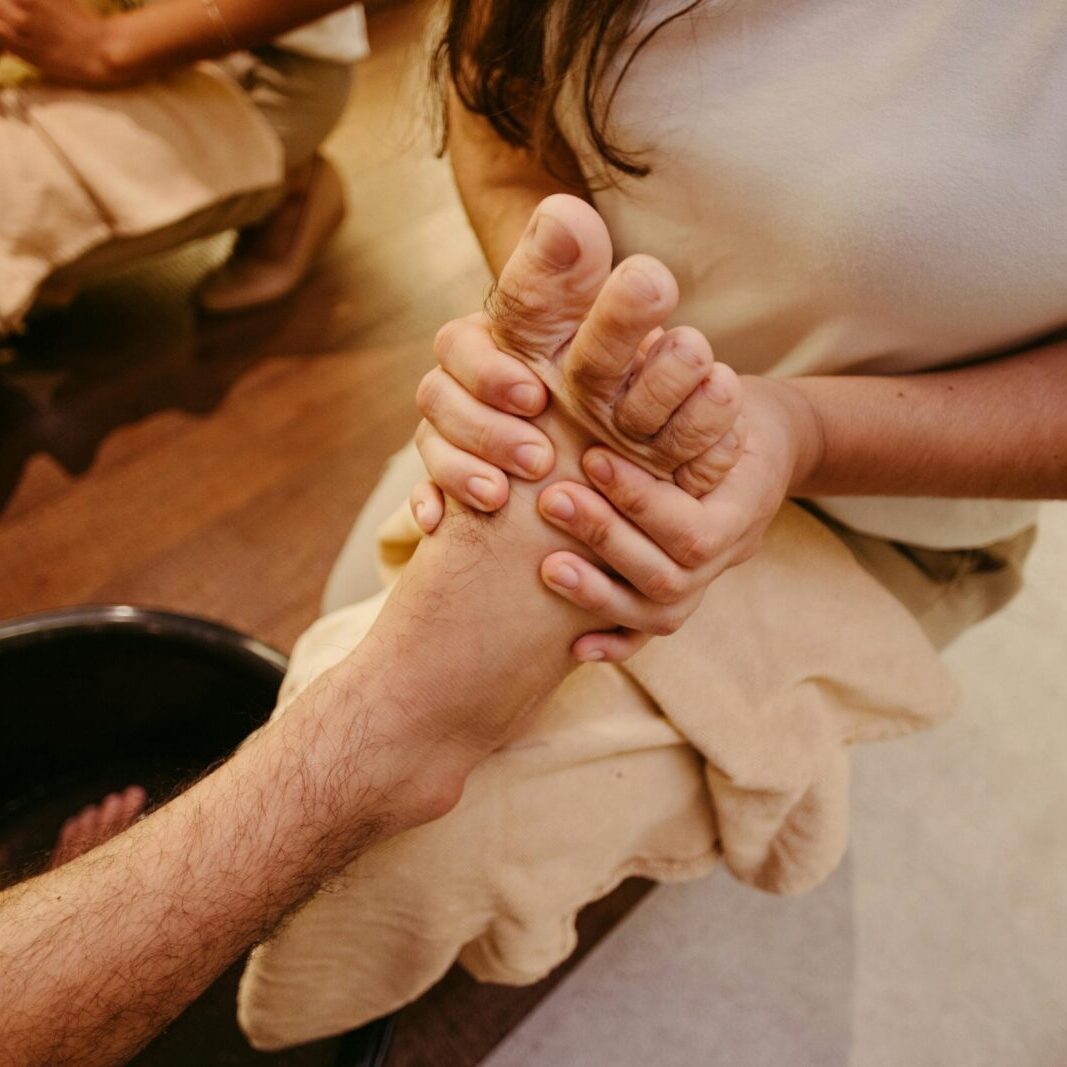 Close-up of a manicure being performed with a nail file on a hand.