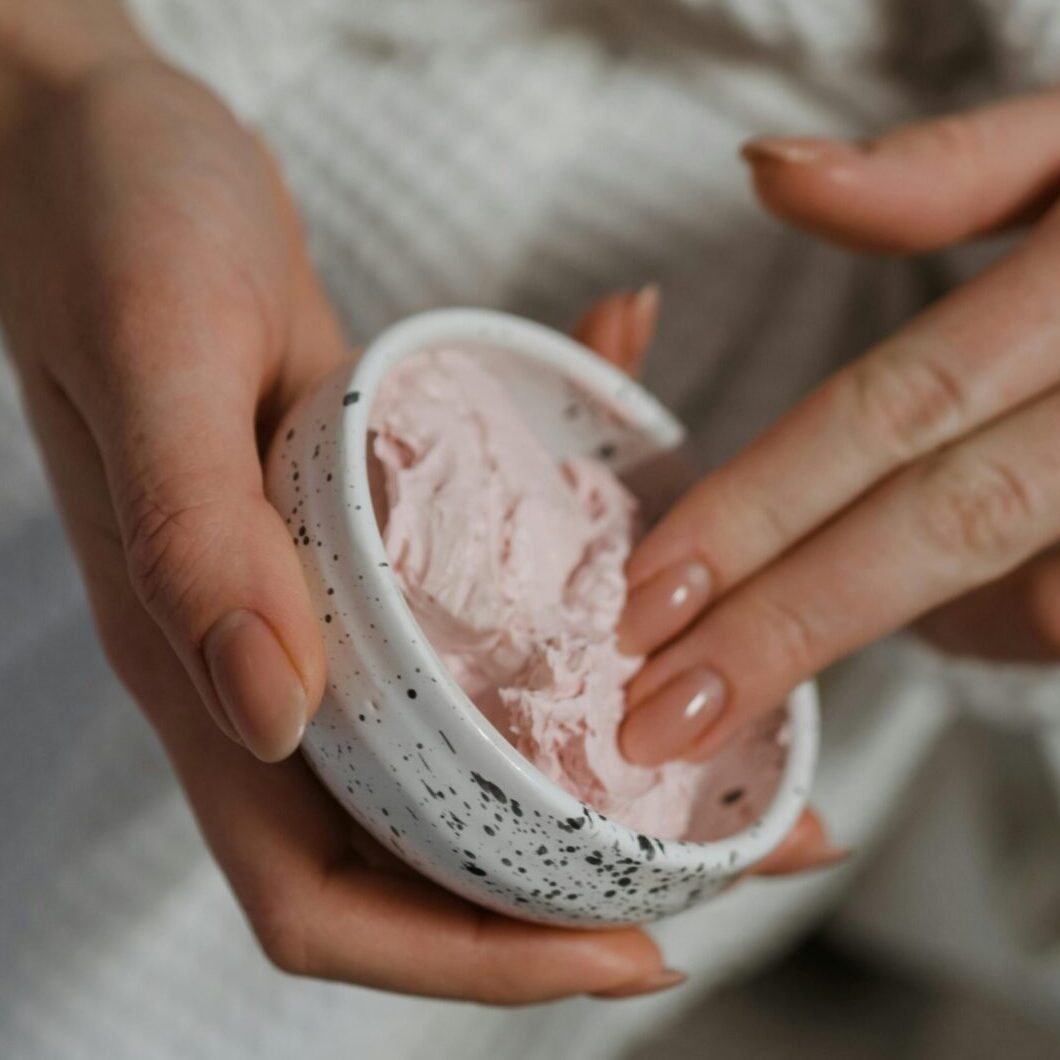 Close-up of a manicure being performed with a nail file on a hand.