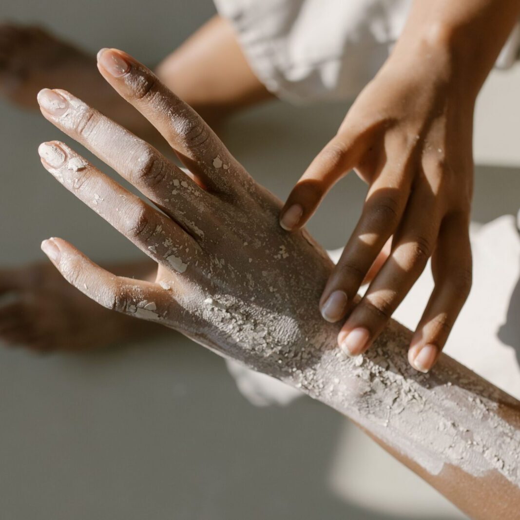 Close-up of a manicure being performed with a nail file on a hand.