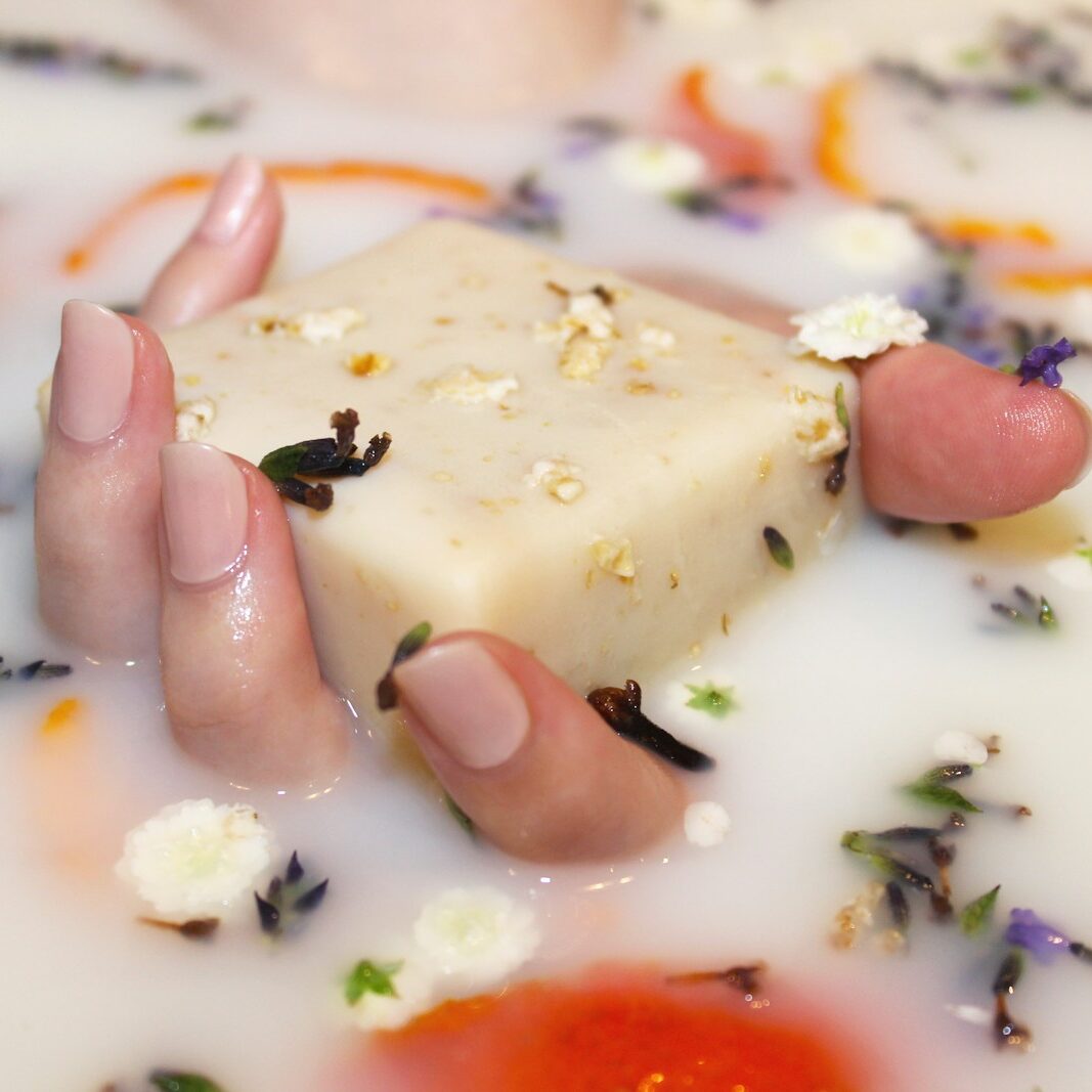Close-up of a manicure being performed with a nail file on a hand.